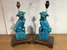 A pair of Chinese turquoise glazed models of Buddhist lion dogs, he with a brocade ball, she with