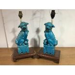 A pair of Chinese turquoise glazed models of Buddhist lion dogs, he with a brocade ball, she with