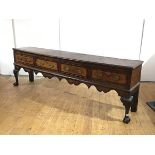 A George II elm low dresser, the rectangular top with moulded edge, above four crossbanded frieze