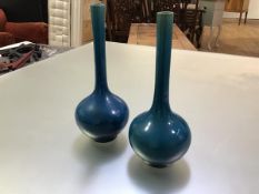 A pair of Chinese turquoise-glazed bottle vases, each with elongated cylindrical neck and unglazed