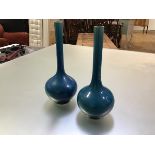 A pair of Chinese turquoise-glazed bottle vases, each with elongated cylindrical neck and unglazed
