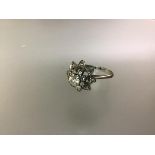 A diamond flowerhead cluster ring, the central round brilliant-cut stone weighing approximately 0.33