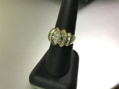 A striking diamond cluster ring, the central marquise-cut claw-set stone weighing approx. 0.65