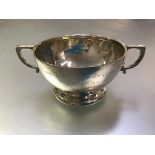 A George V silver twin-handled bowl, London 1925, of tapering form, chased with concentric bands.