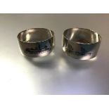 A pair of Egyptian white metal napkin rings, each with niello decoration of dhow and temples, Arabic