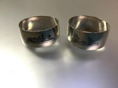 A pair of Egyptian white metal napkin rings, each with niello decoration of dhow and temples, Arabic