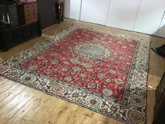 A modern Persian carpet, the central ivory medallion within a madder field decorated with