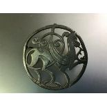 A vintage Shetland Silvercraft silver "Nordic" brooch, circular, modelled with a mythical beast,
