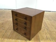 A small rosewood bank of four graduated drawers c.1960, each with turned handles and baize-lined