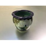 Bough Pottery, a plant pot or cachepot by Richard Amour, painted with flowers against a dark blue