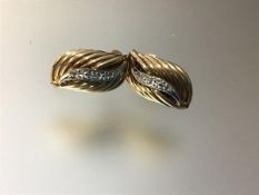 A pair of diamond-set earrings, each with a line of diamond points in a shaped reeded mount, in
