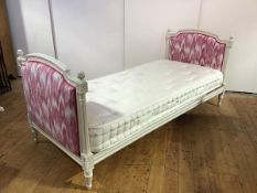 A French white-painted day bed in the Neo-Classical taste, the arched ends with padded pink