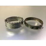 A late Victorian silver cuff bangle, hinged, the scroll-engraved half with beaded edges,
