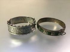 A late Victorian silver cuff bangle, hinged, the scroll-engraved half with beaded edges,