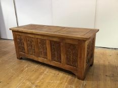 An Arts & Crafts oak coffer, the rectangular incised hinged panel top above recessed panels to the