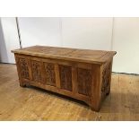 An Arts & Crafts oak coffer, the rectangular incised hinged panel top above recessed panels to the