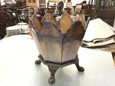 A walnut library waste paper bin, c. 1920, octagonal, of scalloped panels, raised on four shell-