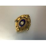 A Victorian blue enamel and yellow metal brooch, c. 1870, of oval form, set with a colourless