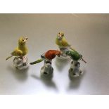 Two pairs of modern Meissen miniature models of birds, one a pair of polychrome parrots, the other a