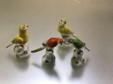 Two pairs of modern Meissen miniature models of birds, one a pair of polychrome parrots, the other a