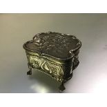 An Edwardian silver jewellery box, Henry Matthews, Birmingham, 1901, of cartouche shape, the cover