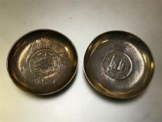 Two Chinese coin-inset silver dishes, early 20th century: the first with a Hsuan Tung dollar