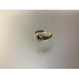A late Victorian single stone sapphire ring, the round-cut stone claw-set on a tapering 18ct