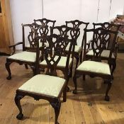 A set of seven George III style mahogany dining chairs, 20th century, each with yoke-shaped top-rail