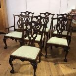 A set of seven George III style mahogany dining chairs, 20th century, each with yoke-shaped top-rail