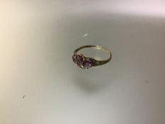 A late Victorian four stone amethyst ring, collet set with a pair of round cut and a pair of