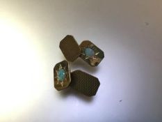 A pair of opal-set 9ct gold chainlink cufflinks, each rectangular plaque with cut-off corners and