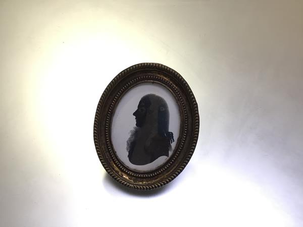 English School, late 18th century, a portrait silhouette of a gentleman, with lace stock, oval, in a