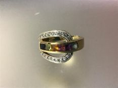 A rainbow sapphire and diamond dress ring, the central channel-set band of vari-coloured square-