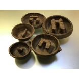 A group of five Ancient Chinese Period carved wooden "buffalo" bowls, the well of each carved with a