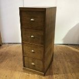 A pitch pine four drawer filing cabinet, early 20th century, with brass cup handles. 132cm by 50cm