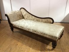A Victorian rosewood day bed, the undulating back and scroll arm upholstered in a gold patterned