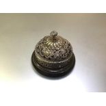 A late Victorian silver-plated lady's desk bell or counter bell, pierced with scrolls, masks and