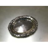 A German 800 silver trinket dish, c. 1900, oval, the rim chased with c-scrolls and with a