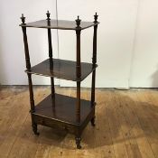 A 19th century rosewood whatnot c.1870, the three moulded tiers surmounted by urn-shaped finials and