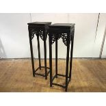 A pair of tall Chinese hardwood jardiniere stands, each with incised square top and pierced frieze