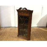 An Edinburgh George III mahogany and satinwood banded hanging corner cabinet c.1800, the swan-neck