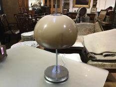 A 1970's mushroom table lamp after a design by Harvey Guzzini, the acrylic shade on a chrome base.