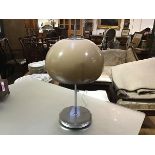 A 1970's mushroom table lamp after a design by Harvey Guzzini, the acrylic shade on a chrome base.