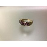 A five stone pink tourmaline ring, the graduated stones collet set between beaded rims, on