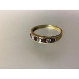 A seven stone ruby and diamond ring, the line of four round-cut rubies spaced by three round