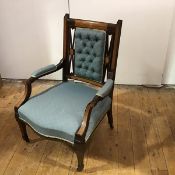 A late 19th century mahogany and inlaid armchair, the upholstered button-back enclosed by scroll