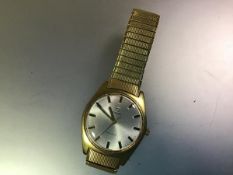 A vintage Omega gentleman's yellow metal wristwatch, c. 1960-70, the silvered dial with baton