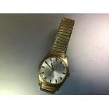 A vintage Omega gentleman's yellow metal wristwatch, c. 1960-70, the silvered dial with baton