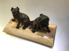 A 19th century parcel-gilt patinated metal or bronze group of two seated bull dogs, probably French,