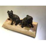 A 19th century parcel-gilt patinated metal or bronze group of two seated bull dogs, probably French,